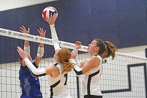 Lexi Gindorff tips the ball at the net with Ava Evenhouse looking on against McDonell Central Catholic during the Marshfield Columbus Invite Saturday, Sept. 27 at Columbus Catholic High School in Marshfield. (Photo by Brett LaBore/Lakeland Times)