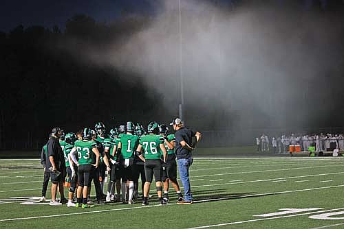 A cloud of baby powder hangs in the air as the Rhinelander High School football team discusses strategy during a timeout in the first quarter of the 91st Bell Game against Antigo at Mike Webster Stadium Friday, Sept. 26. RHS Activities Director Brian Paulson released a statement Monday banning the use of baby powder by student sections moving forward after complaints about its use were raised by game officials, coaches and spectators during and after last Friday’s game. (Photo by Bob Mainhardt for the River News)