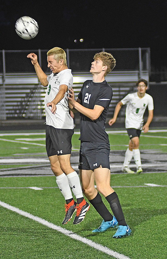 Rhinelander’s Asher Rivord heads the ball against pressure from Lakeland’s Brady Wolfe during first half of a GNC boys’ soccer game in Minocqua Tuesday, Sept. 30. (Brett LaBore/Lakeland Times)