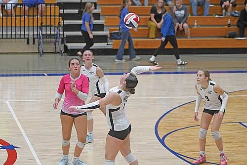 Marlee Strasburg goes for an attack with Greta Johnson, left, and Allyson Seaberg looking on in the third set of a 3-1 win over Merrill Thursday, Oct. 2 at Merrill High School. Strasburg played all-around with seven kills and 12 digs. (Photo by Brett LaBore/Lakeland Times)