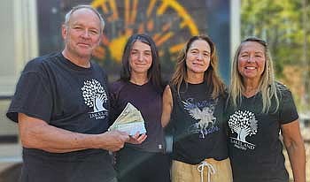 A tailgate event raised $1,500 for the Lakeland Pantry. Those attending the check presentation are, from the left; Bill Olmsted, chairman of the Lakeland Pantry board; Isabelle Johnson and Danna Johnson, owners of the food truck; and Debbie Holzkamp, Lakeland Pantry representative. (Contributed photograph)
