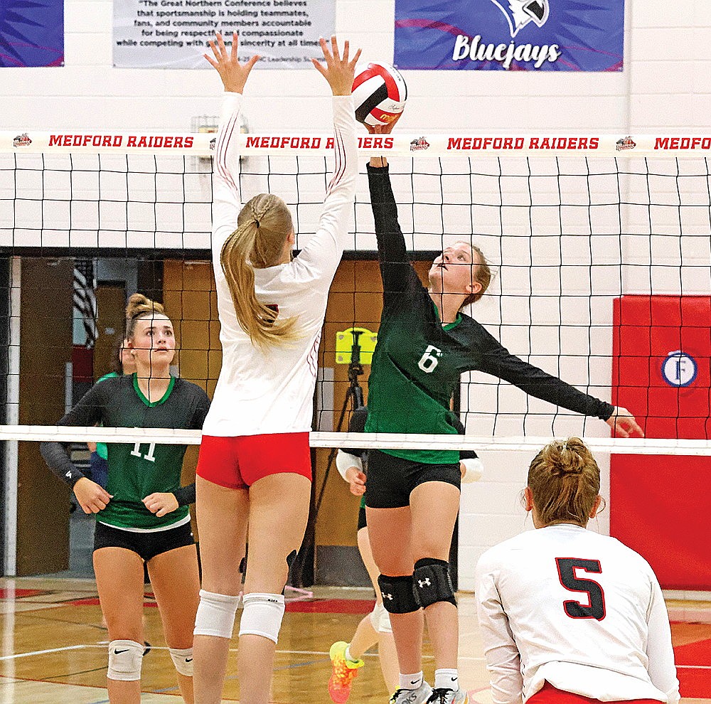 Rhinelander’s Ellie Cummings goes up for an attack against Medford’s Taylor Klingbeil (7) during a GNC volleyball match at Medford Thursday, Oct. 10. Cummings, making her varsity debut, led the Hodags with four kills in a three-set loss to the Raiders. (Matt Frey/Star News)