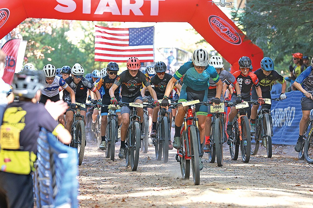 The field leaves the starting line in the MS2 boys’ race during the WICL Hodag Hustle mountain bike festival at Tesomas Scout Camp in Pine Lake Sunday, Oct. 5. Hans Sommer (5508) was second in the race for the RNC team. (Bob Mainhardt for the River News)