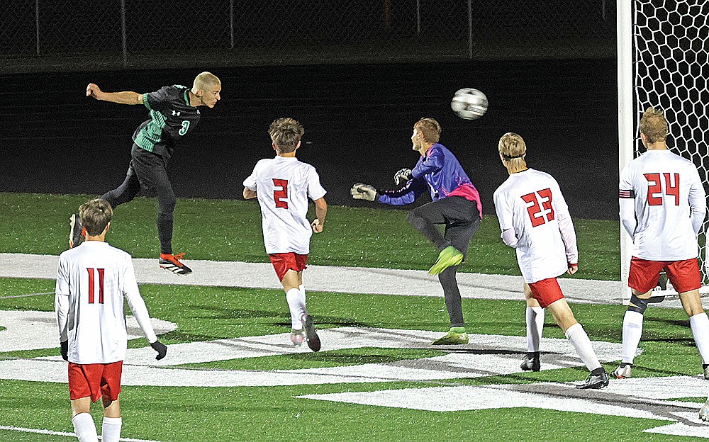 Rhinelander’s Asher Rivord heads a shot past Medford goalkeeper Eric Paul in the first half of a GNC boys’ soccer game at Mike Webster Stadium Tuesday, Oct. 7. Rivord scored on the play, the lone goal in Rhinelander’s 1-0 victory over the Raiders — the first win of the season for the Hodags. (Jeremy Mayo/River News)