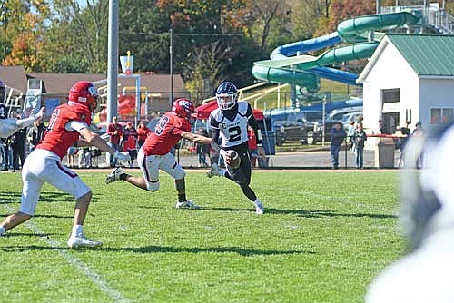 Deklan McQuade is chased by Wausau East’s Malcolm McEachin in the third quarter of a conference game Saturday, Oct. 11 at Thom Field in Wausau. McEachin forced a fumble, resulting in an Iain Stahel, far left, fumble-recovery touchdown. (Photo by Brett LaBore/Lakeland Times)