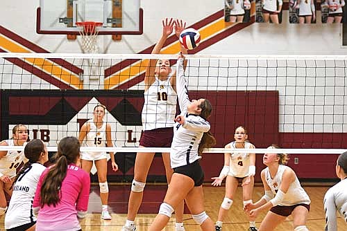 Bryn Warchol looks to hit the ball over the net against the defense of Rib Lake’s Madelyn A in the third set of a non-conference match Thursday, Oct. 9 at Rib Lake High School. (Photo by Brett LaBore/Lakeland Times)
