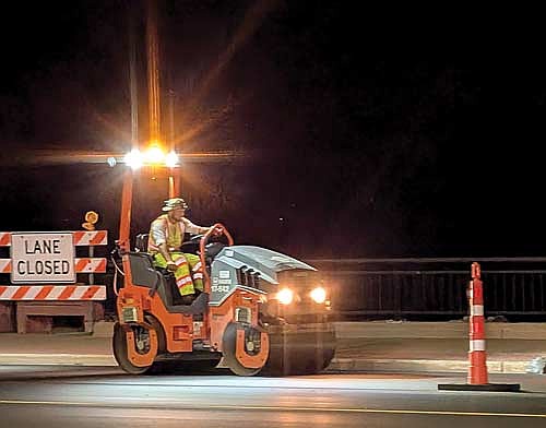 A road construction worker operates a tandem road roller along the Minocqua causeway on Thursday, Oct. 2. (Photo by Dean Hall/Lakeland Times)