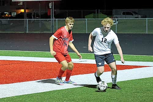 Connor Erickson controls the ball with Medford’s Levi Zuleger behind in the first half of a conference game Thursday, Oct. 9 at Raider Field in Medford. The Thunderbirds clinched at least a share of the Great Northern Conference title with the win. (Photo by Matt Frey/Star News)