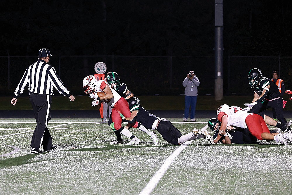 Rhinelander’s Ryley Hull and Rowan Wiczek attempt to tackle Medford’s Carson Ingersoll during the first quarter of a GNC football game at Mike Webster Stadium Friday, Oct. 10. Ingersoll rushed for four touchdowns and the Raiders amassed 275 yards on the ground as they defeated Rhinelander, 42-14. (Bob Mainhardt for the River News)