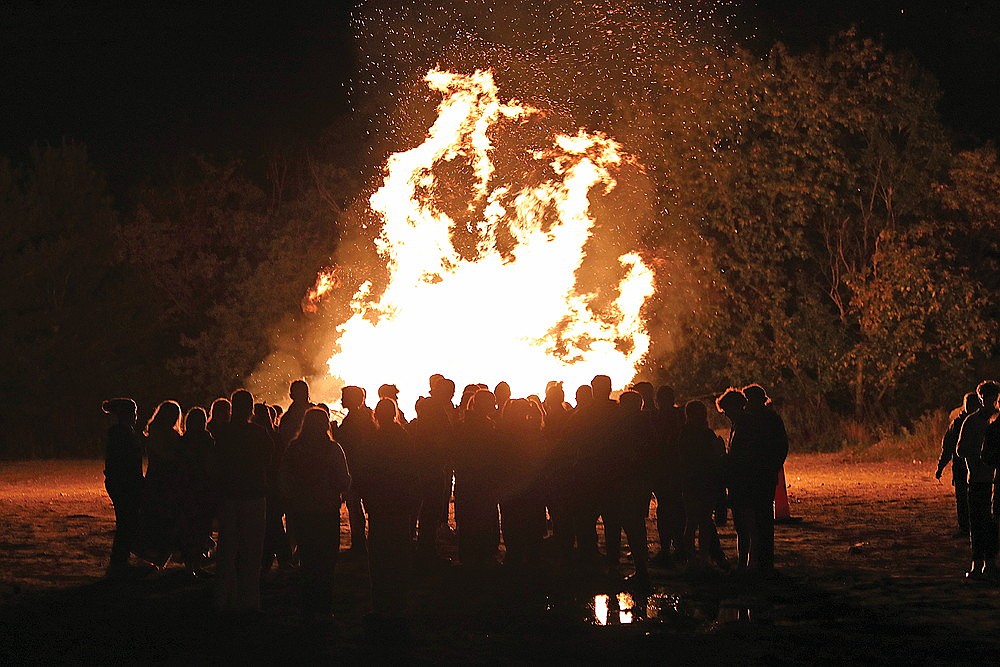Students gather around the bonfire at Hodag Park Monday, Oct. 7. The annual tradition was pushed back a day due to windy conditions.