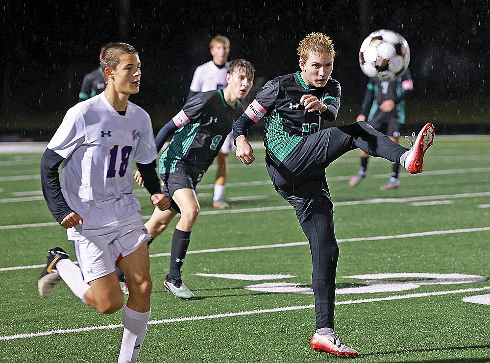 Rhinelander’s Aidan Lueder clears a ball ahead of Northland Pines’ Simon Adamovich during the first half of a GNC boys’ soccer game at Mike Webster Stadium Tuesday, Oct. 14. (Bob Mainhardt for the River News)