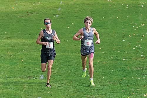 Charlie Ernst, right, runs with Rhinelander’s Avrom Barr during the Great Northern Conference cross country championship meet Saturday, Oct. 18 at Northwood Golf Club in Rhinelander. Barr ended up as the conference champion with Ernst taking second place. (Photo by Jeremy Mayo/River News)