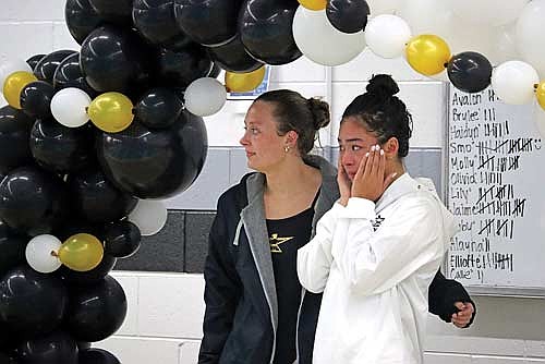 Molly Jorgensen, left, and Olivia Mickle take part in a Senior Night ceremony during a conference dual meet against Colby/Abbotsford Thursday, Oct. 16 at the Lakeland Union High School pool in Minocqua. (Photo by Kate Reichl/Lakeland Times)