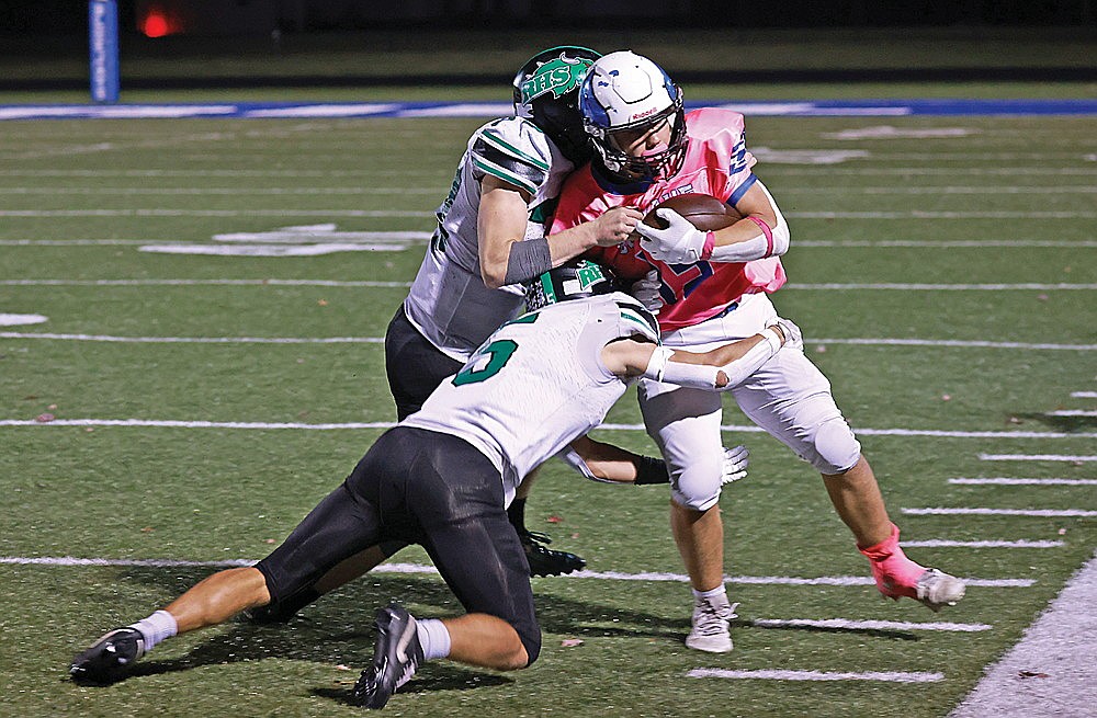 Rhinelander’s Sam Zwaard (5) and Judson O’Malley combine to tackle Merrill’s Kenin Jahnke during of a GNC football game at Merrill Friday, Oct. 17. The Hodags lost the game, 27-13, but secured the 32nd and final qualifying position for the WIAA Division 3 playoffs. (Bob Mainhardt for the River News)