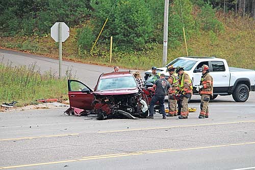 First responders attempt to help 83-year-old Dorothy Hilgart exit from her 2022 Buick Envision in the immediate aftermath of a two-vehicle collision on U.S. Highway 51 near Leary Road on Friday, Oct. 17, in Minocqua. Hilgart was flown from Howard Young Medical Center in Woodruff to Aspirus Wausau for further treatment of injuries, according to Minocqua police. (Photo by Trevor Greene/Lakeland Times)