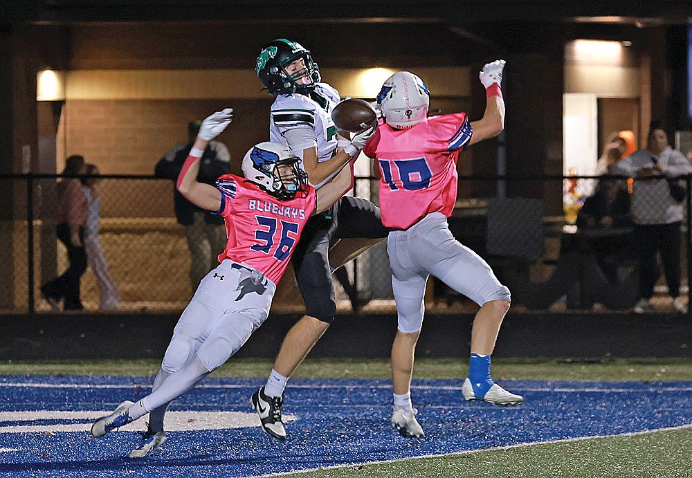 Rhinelander’s Evan Shoeder battles Merrill’s Brody Klebenow (36) and Keylin Allen (18) for a pass in the end zone during a GNC football game at Merrill Friday, Oct. 17. The Hodags lost the game, 27-13,  but secured the 32nd and final qualifying position for the WIAA Division 3 playoffs and will open the tournament tonight at Madison Edgewood. (Bob Mainhardt for the River News)