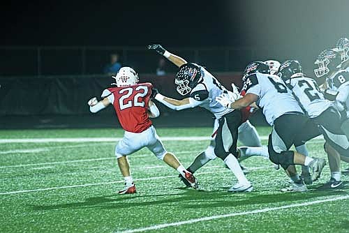 In this Sept. 18, 2025 file photo, Evan Zoch wraps up Medford’s Will Wojcik in the backfield during a conference game at Raider Field in Medford. Zoch was named first team all-conference at wide receiver and second team at defensive end/outside linebacker. (Photo by Brett LaBore/Lakeland Times)