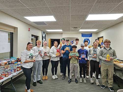 Rhinelander High School FBLA/DECA club members display items they collected during their annual Trick or Can food drive Sunday, Oct. 26. Pictured, from left to right, are Clara Pudlowski, Dylan Shefveland, Lorelai Aylesworth, Emmaline Kramsvogel, Sam Caselton, Soren Dumar, Juan Diego Grage, Kam Kostrova, Liam Kennedy, Charlie Antonuk, Alexa Segovia, Dom Hakala and Josh Haselton. (Contributed photograph)