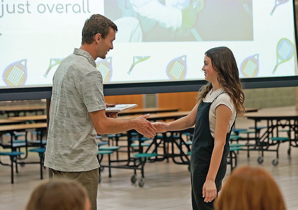Annie Vander Galien receives the Rhinelander High School girls’ tennis team’s MVP award from coach Matt Nichols during the team’s banquet in the RHS commons Monday, Oct. 27. (Bob Mainhardt for the River News)