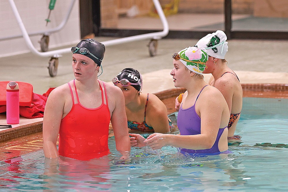 From left to right, Rylee Mickevicius, Ella Heck, Emma Houg and Vivian Lamers listen during Rhinelander High School girls’ swim team practice in the Heck Family Community Pool Tuesday, Nov. 4. The four are all projected to qualify for state in multiple events as the Hodags prepare to swim in a WIAA Division 2 sectional meet Saturday, Nov. 8 in Rice Lake. (Bob Mainhardt for the River News)
