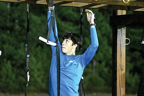 Parker McKinney swings on the monkey bars during practice Tuesday, Nov. 4 at Marshfield Clinic Woodruff Center. (Photo by Brett LaBore/Lakeland Times)