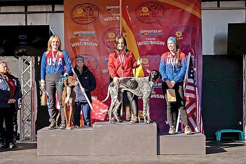 Niina Baum, far left, stands on the podium with her dog Dusty after her second-place finish in the 1-Dog Scooter at the IFSS Dryland Mushing World Championships Oct. 21-26 at Minocqua Winter Park. (Photo by Daniel T Photography)