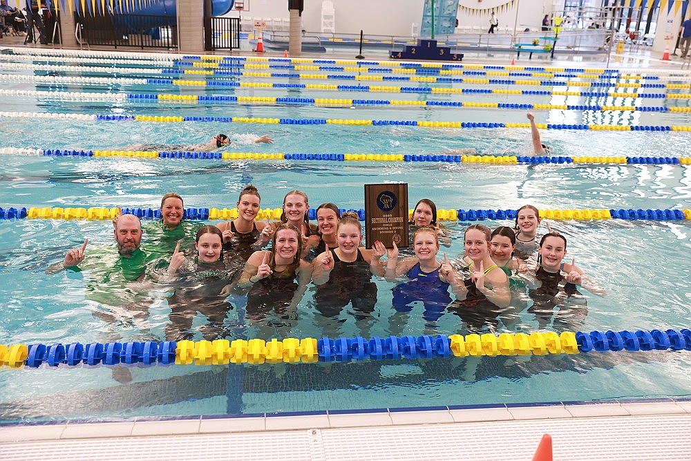 The Rhinelander High School girls’ swim team celebrates with the sectional plaque after winning a WIAA Division 2 sectional in Rice Lake Saturday, Nov. 8. Pictured in the front row, from left to right, are assistant coach Brent Olson, Hailey Novak, Vivian Lamers, Emma Houg, Millie Gruett, Rylee Mickevivius, Kyleigh Kennedy and Lola Beach. In the back row are head coach Jenny Heck, Ella Heck, Kiley Pooch, June Chiamulera, Maria Craig and Kyree McMahon. (Bob Mainhardt for the River News)