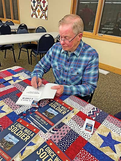 Jerry Rayala signs copies of his book at Ascension Lutheran Church in Minocqua on Thursday, Oct. 30. (Photo by Brian Jopek/Lakeland Times)