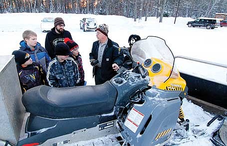 In this 2017 file photo, Mike MacKenzie goes over safety instructions with his own snowmobile outside on Thursday, Jan. 12, 2017 at North Lakeland School in Manitowish Waters. (Photo by Dean Hall/Lakeland Times)