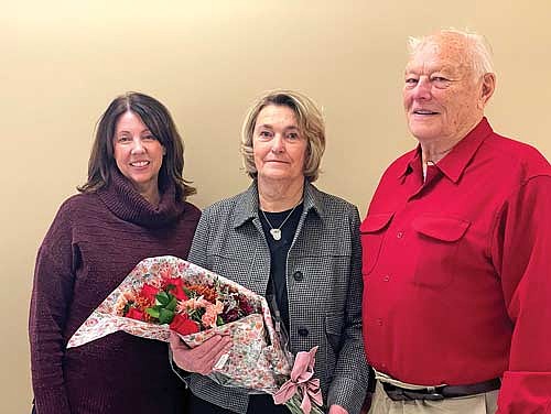 Valerie Wielhower, left, director of the Vilas County human services department, Helga Low and county supervisor Marv Anderson, who presented Low with a bouquet of flowers during the Vilas County board meeting on Wednesday, Nov. 12. (Photo by Brian Jopek/Lakeland Times)