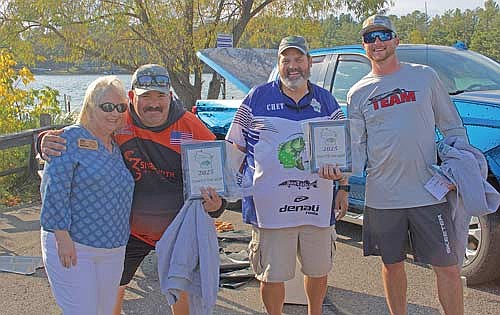 Robin Pester (left) and Kacey Meyer (right) took Team of the Year honors for the Wisconsin Bass Team Trail. They are pictured here with WBTT weigh master Chet Netzel and Sherry Hulett of the Minocqua Area Visitors Bureau. The team secured free entry into each of the qualifying tournaments for the 2026 season as well as a guaranteed spot in the championship for 2026. (Photo by Beckie Gaskill/Lakeland Times)