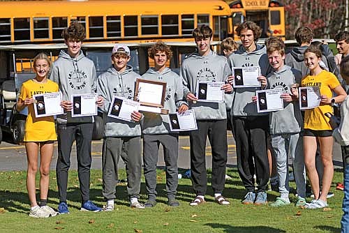 In this Oct. 18, 2025 file photo, cross country runners, from left, Emerson Rubo, Barrett Eggen, Charlie Ernst, Brayden Kelly, Parker McKinney, Hunter Massignan, Kaden Redman and Addison Eggen celebrate their conference accolades following the Great Northern Conference Meet at Northwood Golf Club in Rhinelander. (Photo by Brett LaBore/Lakeland Times)