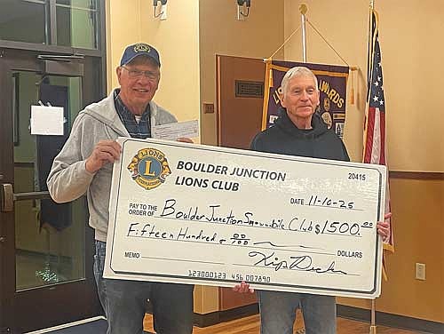 The Boulder Junction Lions Club presented a $1,500 donation to the Boulder Junction Snowmobile Club to help with fundraising for the Snowmobile Club’s new equipment barn. Those attending the check presentation are, from left, Kip Decker, Boulder Junction Lions Club president, and Don Zander, Boulder Junction Snowmobile Club president. (Contributed photograph)