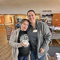 Lorna Springate, Lakeland Pantry director, left, accepts $3,000 in Trig’s gift cards from Liz Del Bosque, store director for Trig’s in Minocqua. (Contributed photograph)