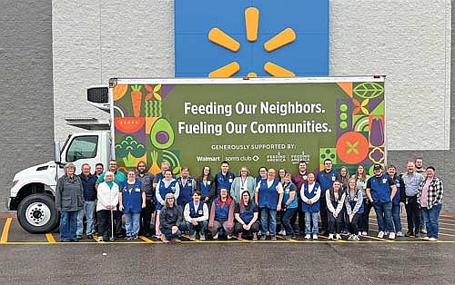 Representatives from the Rhinelander Area Food Pantry and Walmart of Rhinelander pose for a photograph Tuesday, Nov. 25, celebrating the donation of a new box truck to the pantry. (Contributed photograph)