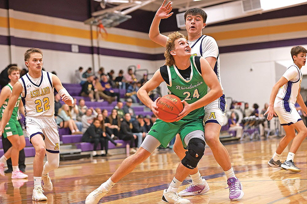 Rhinelander’s Abe Gretzinger drives against Ashland’s Gavin Greene during the first half of a non-conference boys’ basketball game in Ashland Monday, Dec. 1. Gretzinger scored a game-high 23 points in the Hodags’ 75-41 win. (Bob Mainhardt for the River News)
