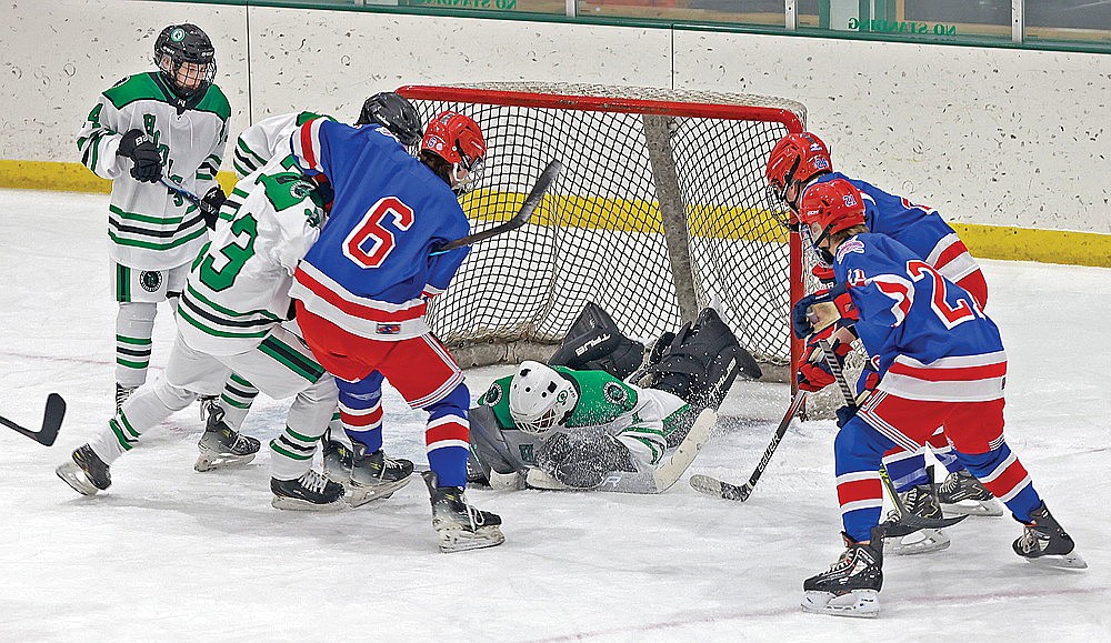 Rhinelander goaltender Connor McGee dives to cover the puck in front of Northland Pines’ Cooper Saari during the first period of a GNC boys’ hockey game at the Rhinelander Ice Arena Tuesday, Dec. 2. McGee made 48 saves in Rhinelander’s 14-1 loss to the Eagles. (Bob Mainhardt for the River News)