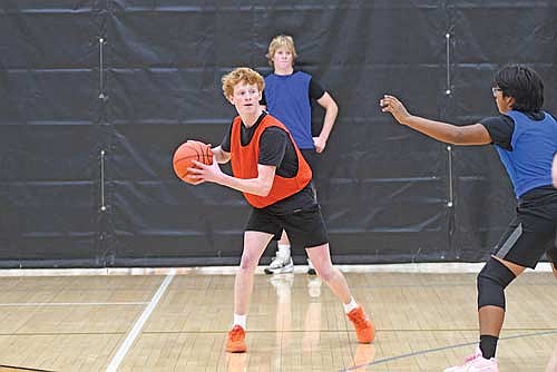 Junior Jack Stella, front, looks to make a pass with sophomore Gabe Karch looking on during the first day of practice Monday, Nov. 17 at the Lakeland Union High School fieldhouse in Minocqua. (Photo by Brett LaBore/Lakeland Times)
