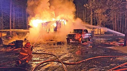 Firefighters from nine area fire departments fought a fire that destroyed a mobile home on Lakeshore Drive in Pine Lake on the morning of Nov. 27, Thanksgiving Day. (Contributed photograph)