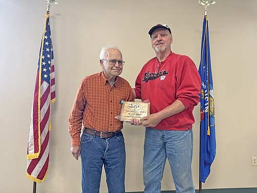 Dr. Gary Bailey accepts the Don and Nancy Wallace distinguished service award by Bill Andrews at the Big Arbor Vitae Lake Association annual meeting over Memorial Day weekend. (Contributed photograph)