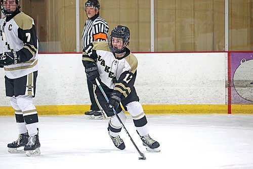Palmer Bain controls possession in the home and conference opener against Tomahawk Tuesday, Dec. 2 at the Lakeland Hawks Ice Arena in Minocqua. (Photo by Kate Reichl/Lakeland Times)