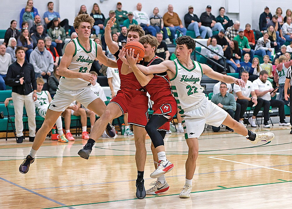 Rhinelander’s Vince White battles for a rebound against Medford’s Will Daniels and Nick Krause during the second half of a GNC boys’ basketball game at the Jim Miazga Community Gymnasium Friday, Dec. 5. (Bob Mainhardt for the River News)