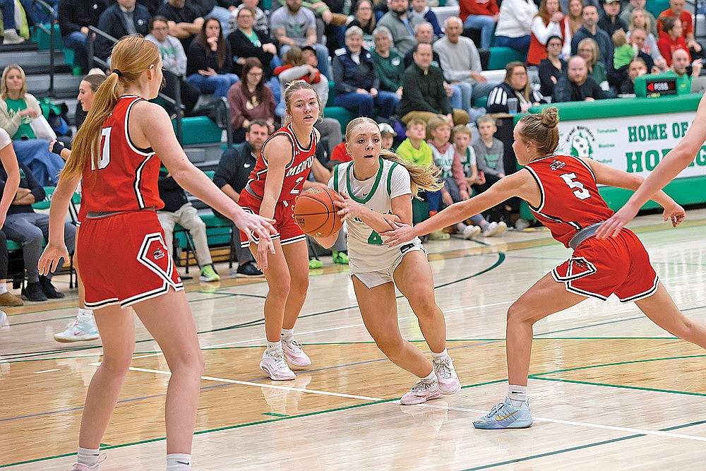 Rhinelander’s Teagan Clark look to pass guarded by multiple Medford defenders during the second half of a GNC girls’ basketball game at the Jim Miazga Community Gymnasium Friday, Dec. 5. Rhinelander shot 27% from the field Friday and fell to the Raiders, 55-45. (Bob Mainhardt for the River News)