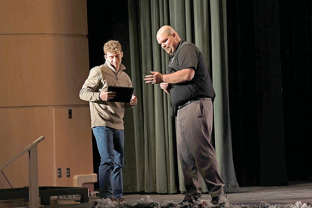 Ben Olson is presented with the Rhinelander High School football team’s Hodag Award from head coach Aaron Kraemer during the team’s banquet Sunday, Dec. 7 in the John and Dori Brown Performing Arts Center. (Bob Mainhardt for the River News)