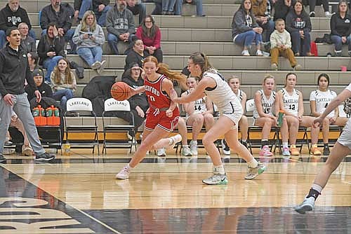 Medford’s Kayla Baumgartner looks to get by Ava Evenhouse in the first half of a conference game Friday, Dec. 12 at Ted Voigt Court in Minocqua. Baumgartner finished the game with 23 points and Evenhouse 17 points. (Photo by Brett LaBore/Lakeland Times)