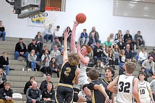 Sean Morgan scores a basket over Hayward’s Kaden Knight in the second half of a non-conference game Tuesday, Dec. 16 at Ted Voigt Court in Minocqua. Morgan scored his first two varsity baskets. (Photo by Brett LaBore/Lakeland Times)