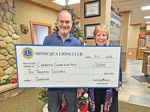 Matt Hammes, treasurer of the Minocqua Lions Club, presents a $10,000 donation to Sandy Madden, executive director of the Campanile Center for the Arts, in support of arts access and education in the Northwoods. (Contributed photograph)