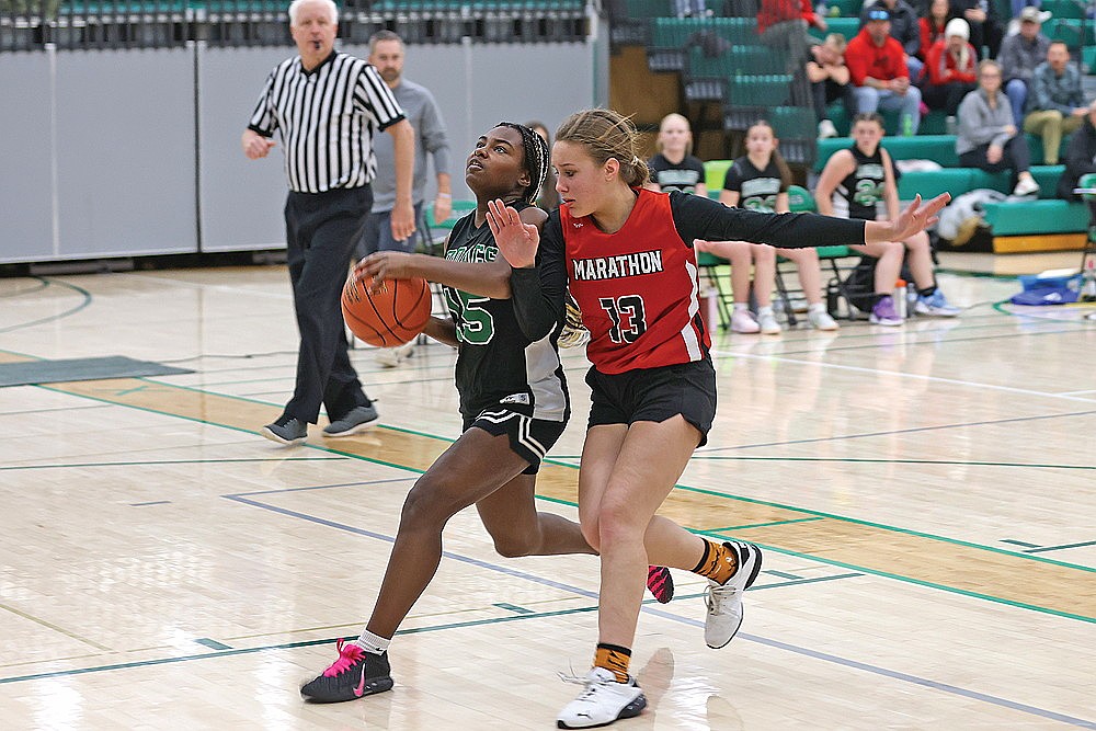 Olivia Eades drives to the basket through contact for the Hodag eighth graders against Marathon.