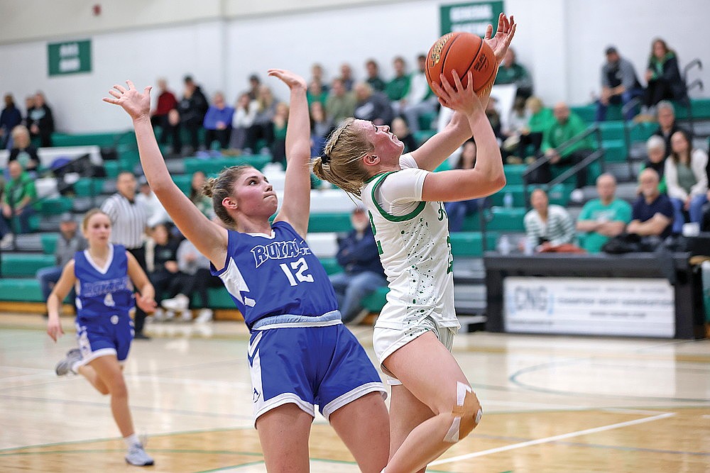 Rhinelander’s Vivian Lamers drives past Wisconsin Rapids Assumption’s Elayna Aue for a basket during the second half of a non-conference girls’ basketball game at the Jim Miazga Community Gymnasium Monday, Dec. 22. Lamers scored a game-high 13 points as the Hodags knocked off the Royals, ranked No. 2 in Division 5, 50-22. (Bob Mainhardt for the River News)