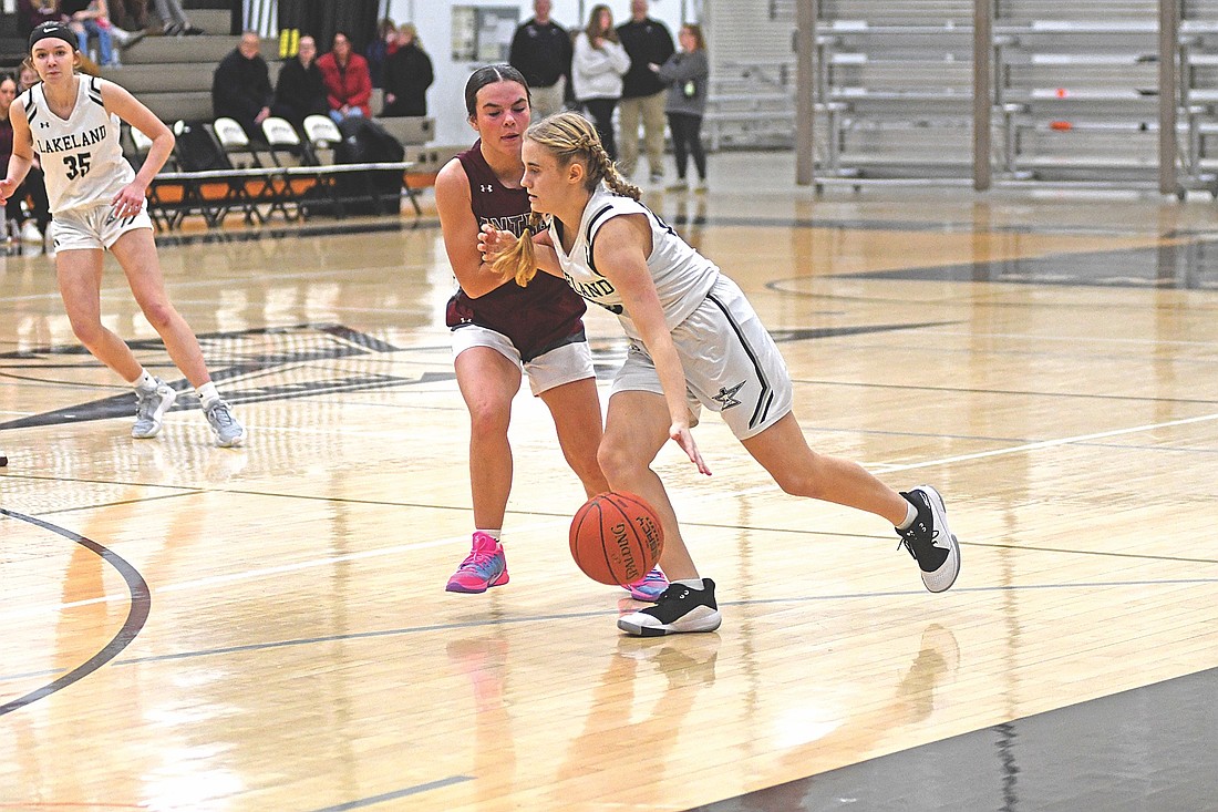 Carmen Istudor drives into the arc defended by Antigo’s Ava West in the second half of a conference game Friday, Dec. 19 at Ted Voigt Court in Minocqua. (Photo by Brett LaBore/Lakeland Times)